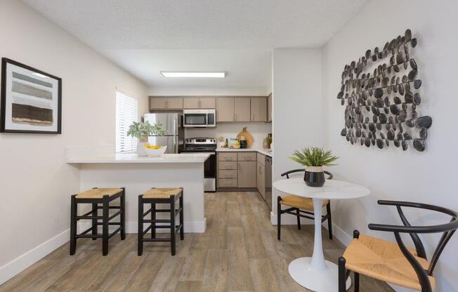 an open kitchen and living room with a table and chairs