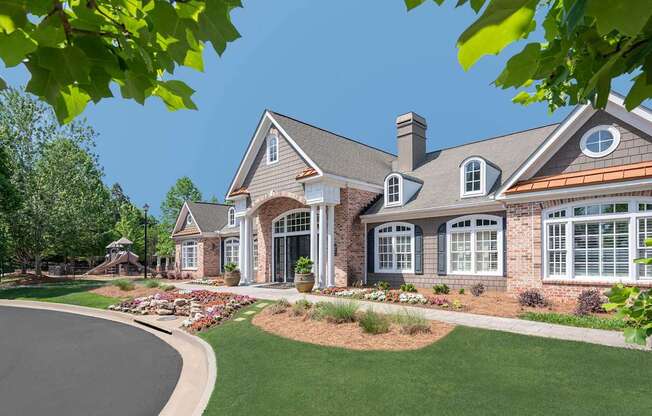 A large house with a grey roof and a white window.