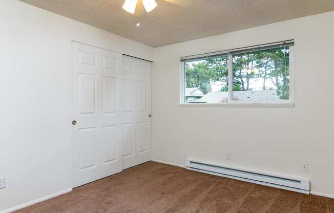 Pinewood Terrace Apartments | First bedroom showing closet doors and window