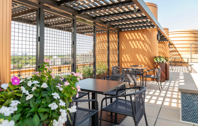 an outdoor patio with tables and chairs and a pergola