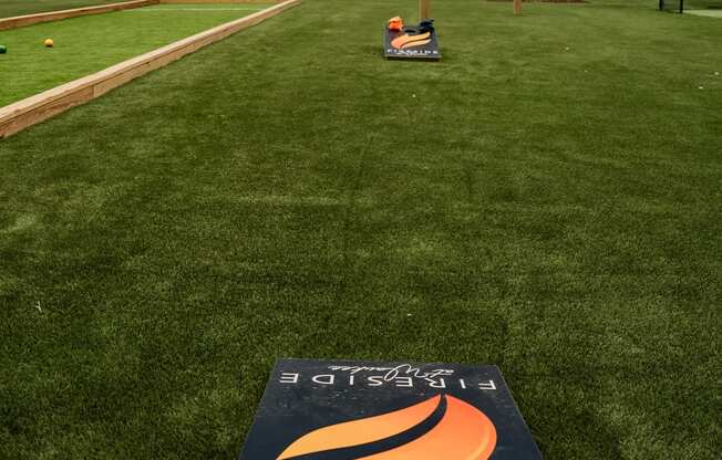 a baseball field with a sign in the middle of the grass