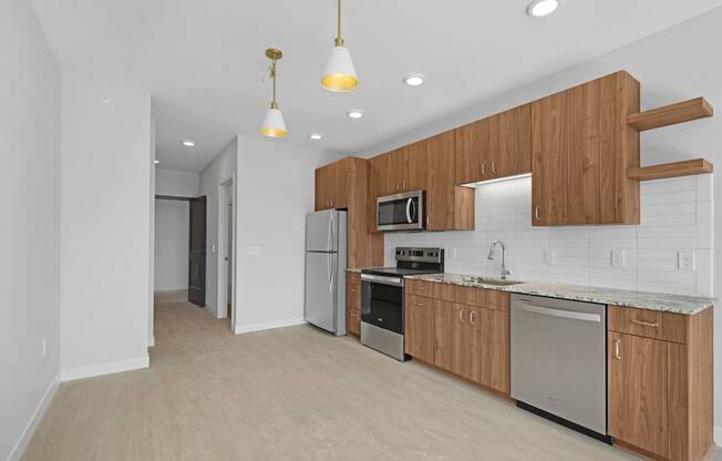 a kitchen with wooden cabinets and stainless steel appliances