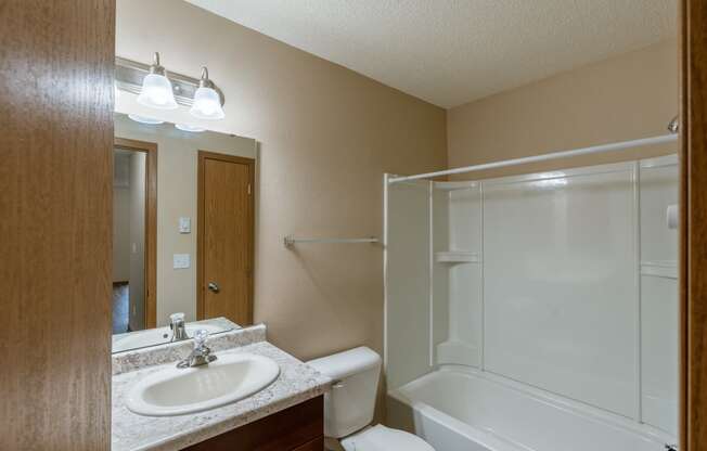 Grand Forks, ND Richfield Apartments. A bathroom with a sink, toilet, and bathtub