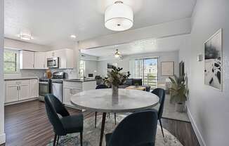 an open kitchen and dining room with hard surface floors at The Crossings Apartments, Michigan, 49508