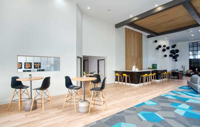 a lobby with tables and chairs and a bar at Presidio Palms Apartments, Arizona