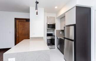 a kitchen with stainless steel appliances and a white counter top