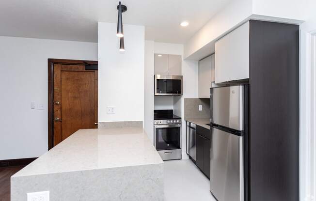a kitchen with stainless steel appliances and a white counter top