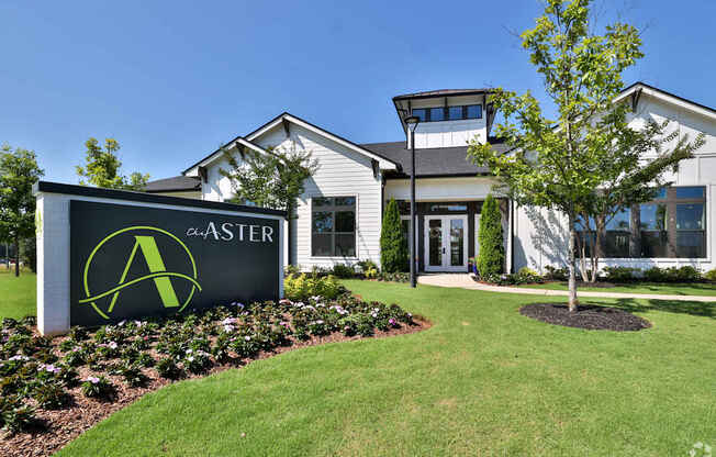 A sign for ASTER in front of a building.
