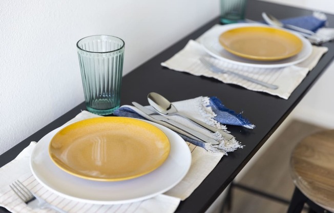 a dining table set with plates and bowls and a glass at Analog PDX, Oregon
