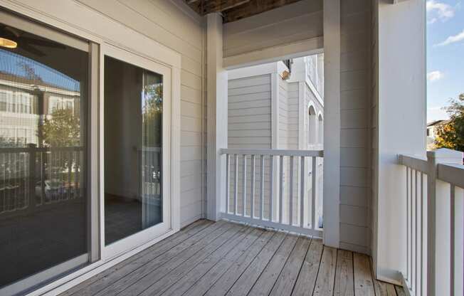 the deck of a home with sliding glass doors