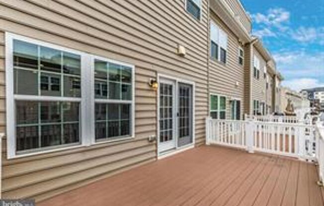 Three level townhouse with wood floor on main level, 2 car garage in the back