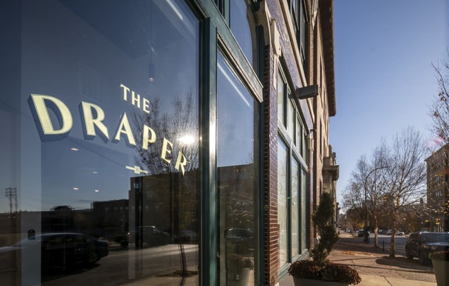 the drapery store front with a large glass window with the droppa sign at The Draper, St Louis, 63103