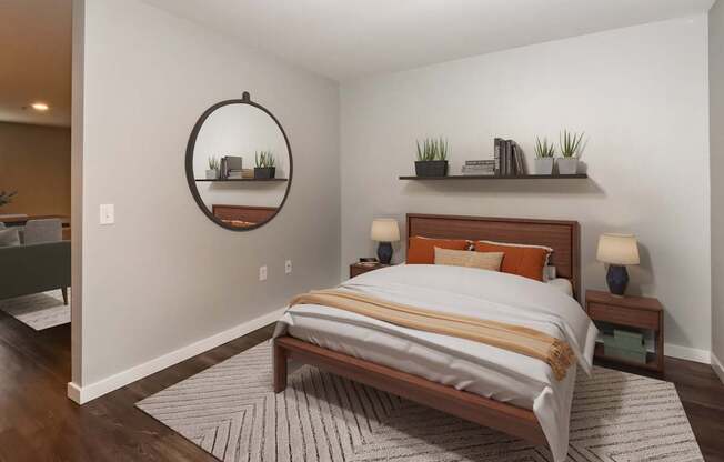 A bedroom with a large bed and a mirror on the wall.