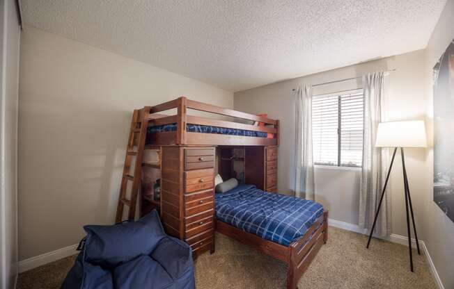 Bedroom with a bunk bed and a window at 2900 Lux Apartment Homes, Nevada