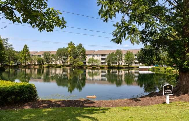 a lake with a sign in front of a building