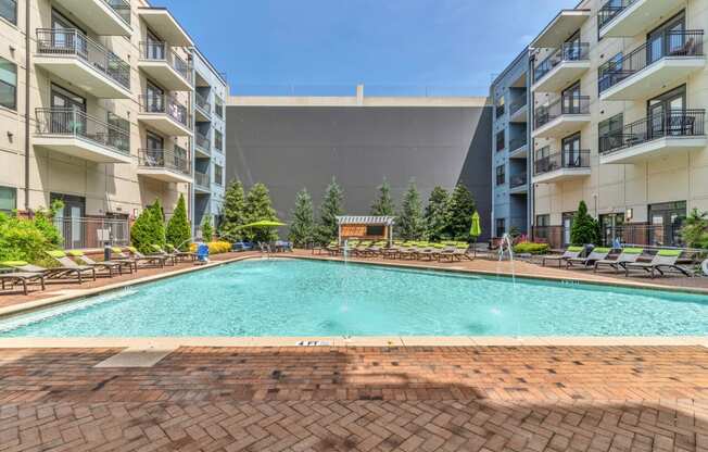 a swimming pool in front of an apartment building