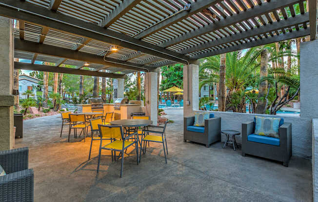 A patio with a table and chairs under a roof.
