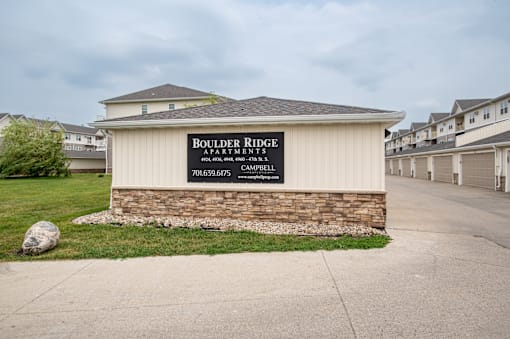 a building with a sign that says boulder river apartments