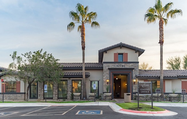 a building with two palm trees in front of it