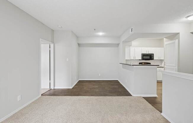 B2 living room with a kitchenette in the background at Jefferson Place Apartments in Irving, TX