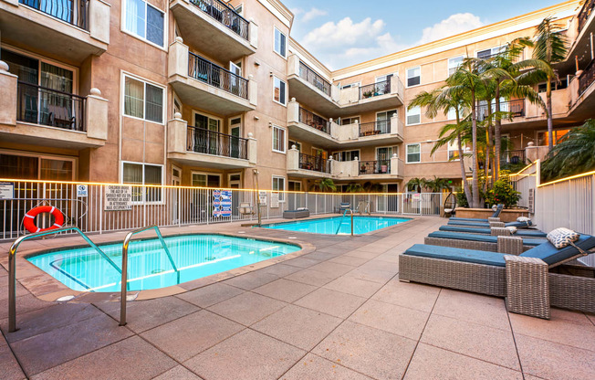 Pool and jacuzzi with lounge seating