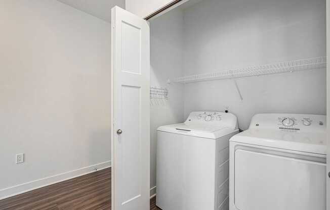 A laundry room with a washer and dryer at Meadowbrooke Apartment Homes in Kentwood, MI 49512