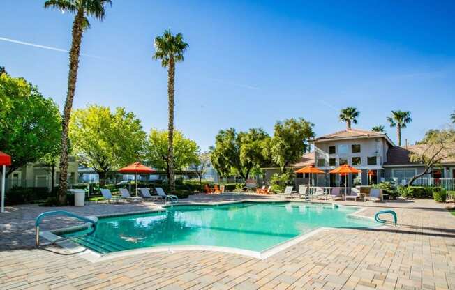 Octave Apartments in Las Vegas, Nevada Clubhouse Exterior and Large Pool with Lounge Chairs at Octave Apartments, Nevada