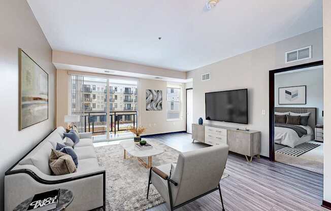 A living room with a grey sofa and a television.