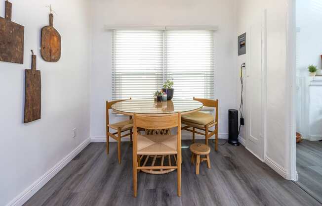 a dining area with a wooden table and four chairs