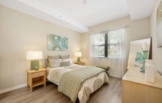 a bedroom with a large bed and a mirror