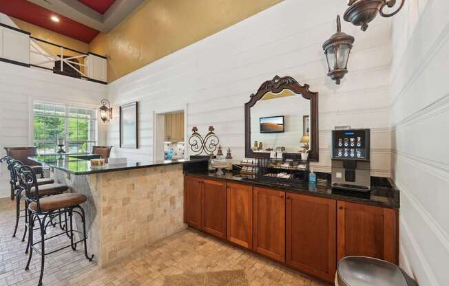 A bar area with stools and a coffee machine station.