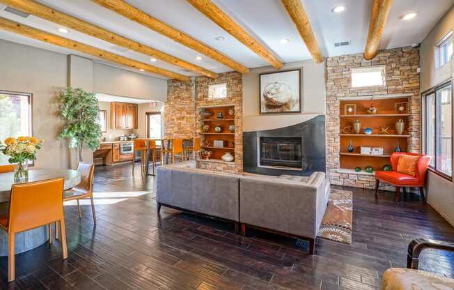 a living room with a fireplace and a table and chairs