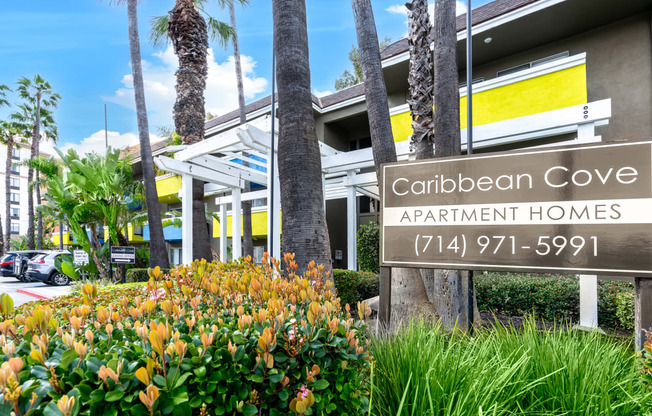 a building with a sign that reads caribbean cove apartment homes