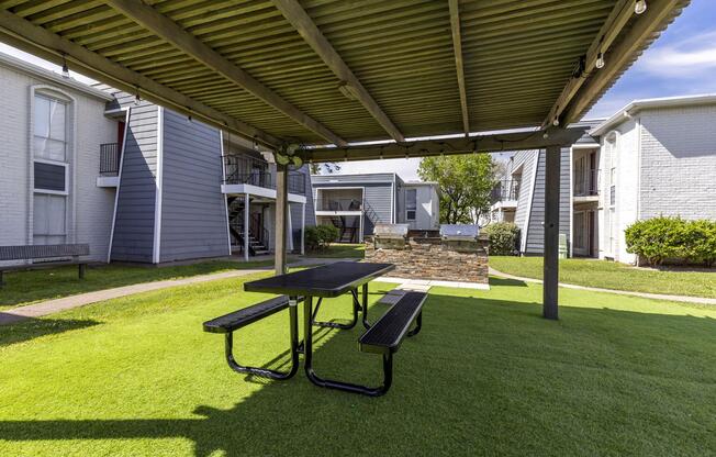 a couple of lawn chairs sitting on a bench in front of a building