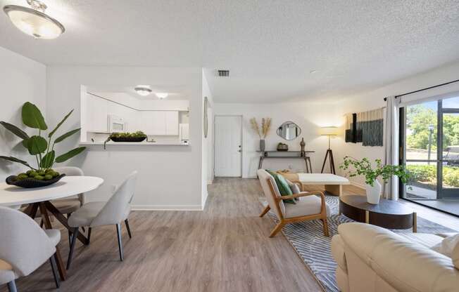 the living room and dining area of an apartment