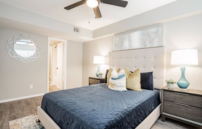 a bedroom with a bed and a ceiling fan