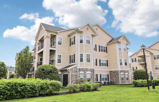 A large, well-maintained apartment building with multiple balconies and windows.