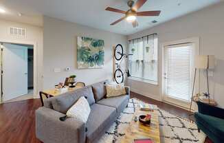 a living room with a couch and a coffee table at The Bend Arbordale, Williamsburg