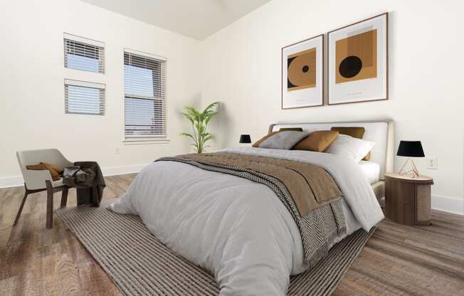 a bedroom with a bed and two paintings on the wall