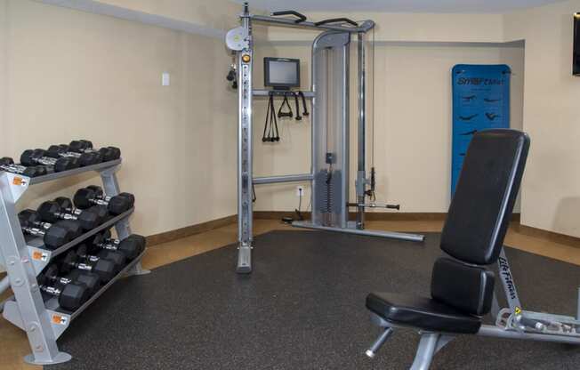 a gym with a treadmill and weights