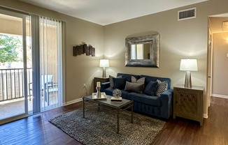 a living room with a blue couch and a coffee table