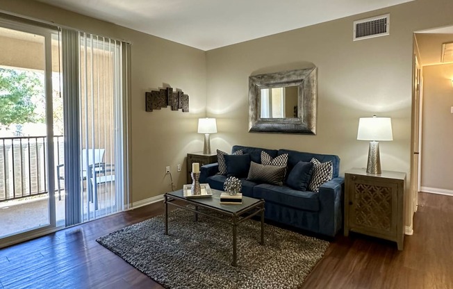 a living room with a blue couch and a coffee table