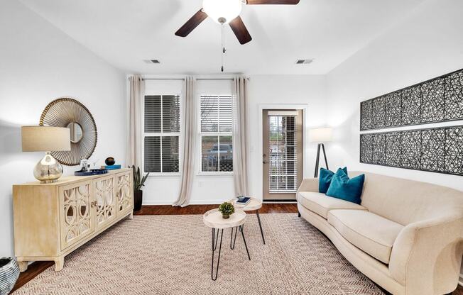 a living room with a couch and a ceiling fan