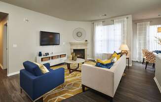 a living room with a couch and a chair and a television