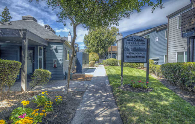 A sign for Sierra Glen Leasing Center stands in front of a building at Sierra Glen Apartments, California, 95621
