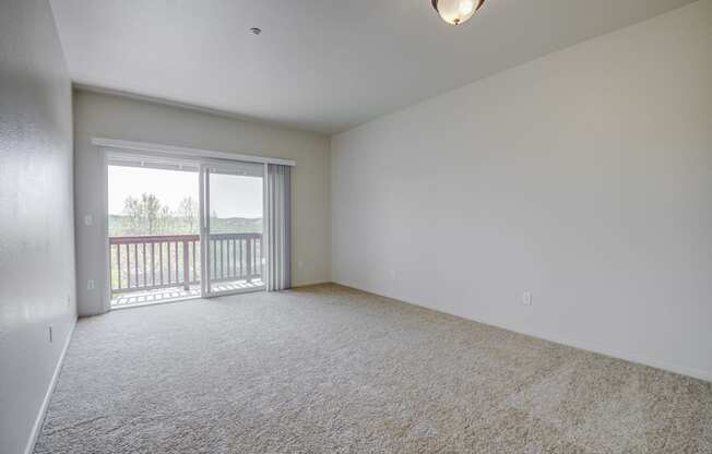 a bedroom with a sliding glass door and a carpeted floor  at Seville at Gale Ranch, San Ramon, 94582