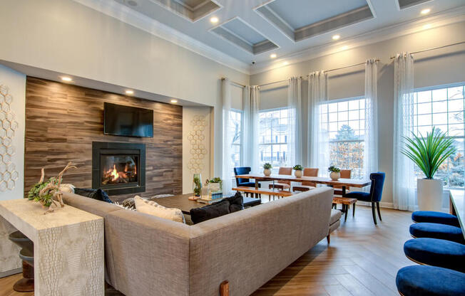 a living room with a fireplace and a dining room in the background