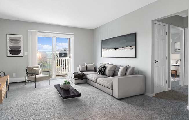 Model Living Room with Carpet and Patio Accessibility at Stone Ends Apartments in Stoughton, MA.
