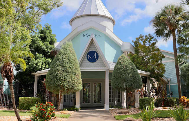 A white building with a blue roof and a sign that says "Marson".