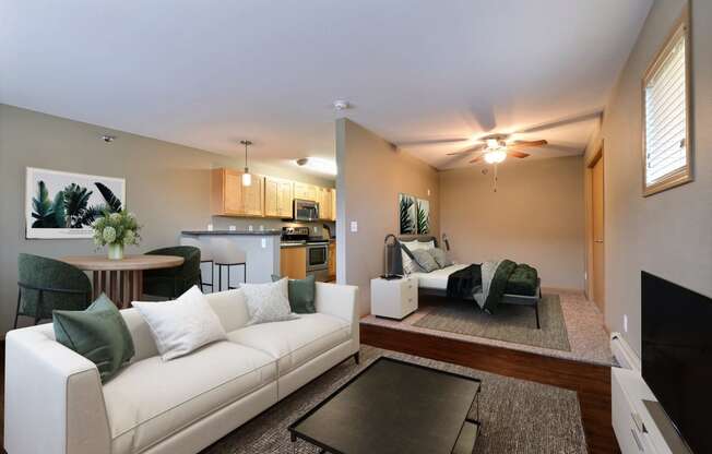 a living room with a white couch and a table. Fargo, ND Urban Plains Apartments